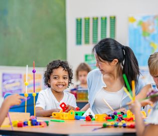 Child Care Assistant with a child in a centre