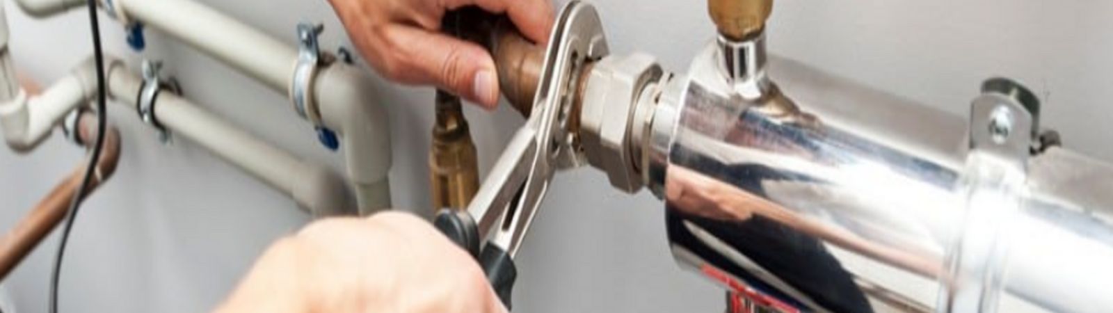 plumber working on pipes.